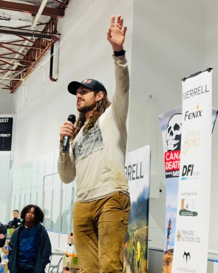 Matt Shepard speaking to a crowd at the Canadian Death Race, microphone in hand